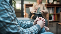 Patient sits and talks with therapist during psychoanalysis session.